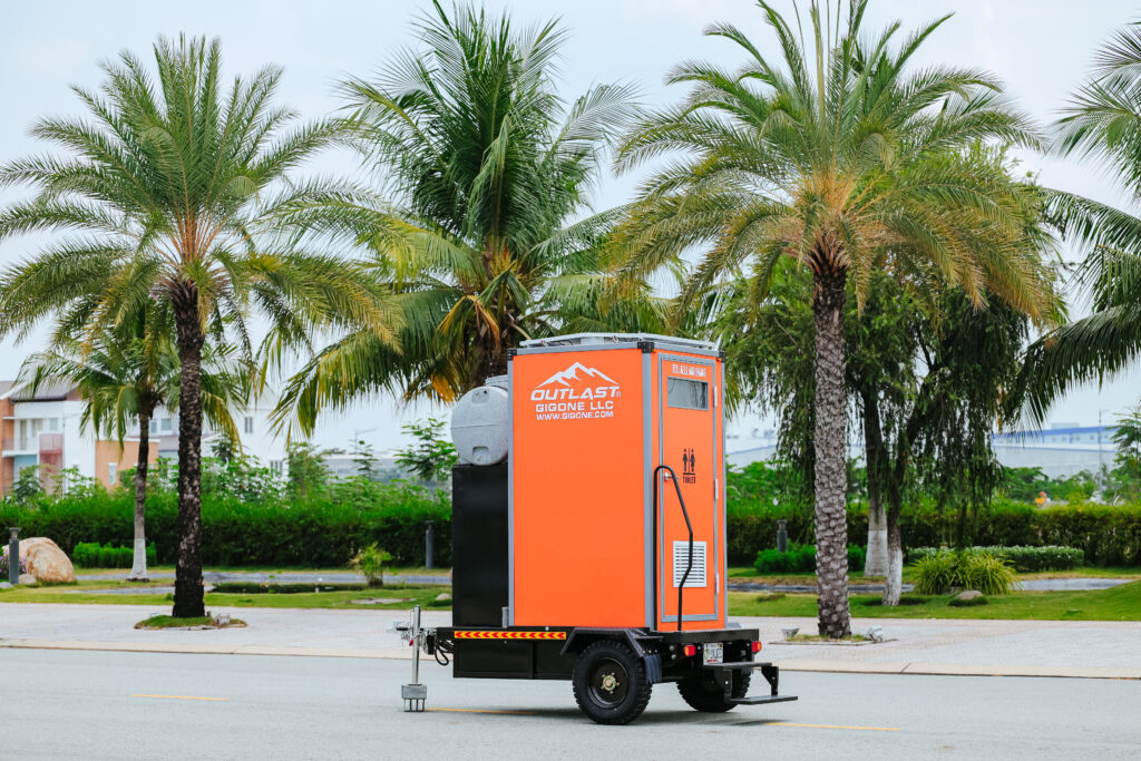 An orange trailer with a black and white logo on it